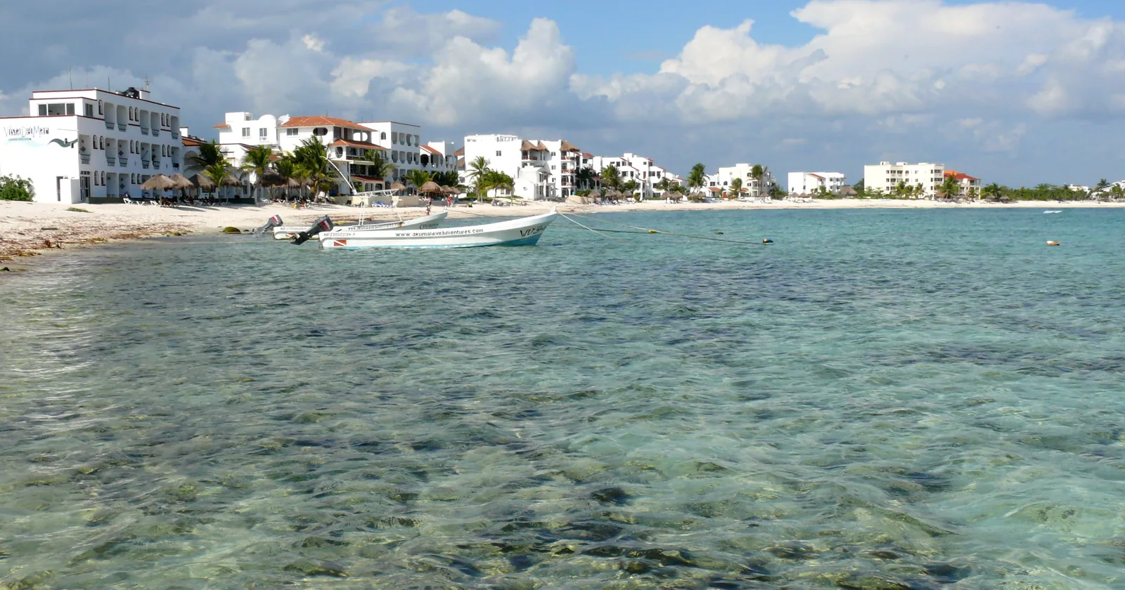 The shallow clear water and low buildings of Half Moon Bay at Akumal, Quintana Roo