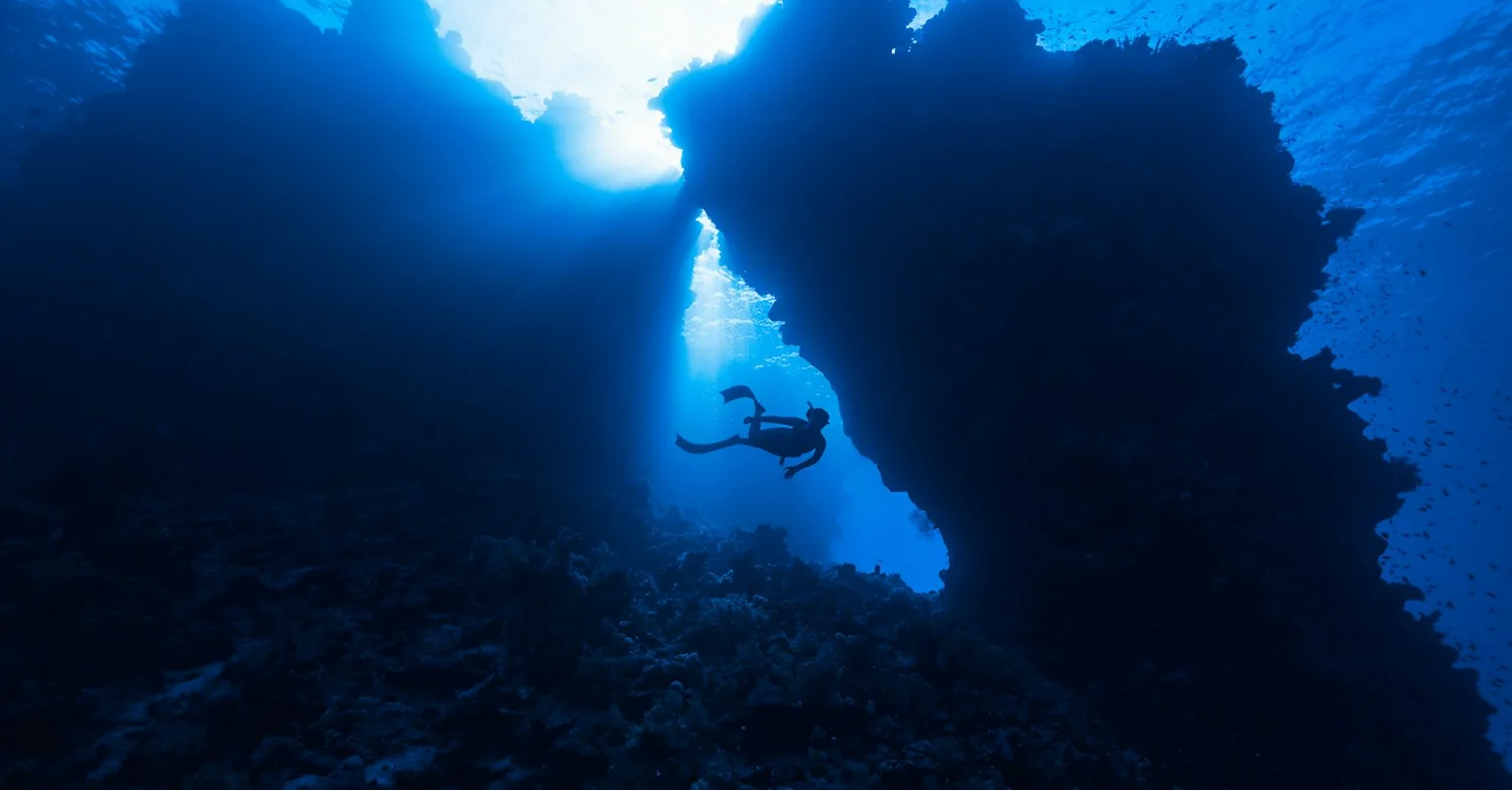 Limestone cliffs dropping into clear blue water on the Turkish Mediterranean coast