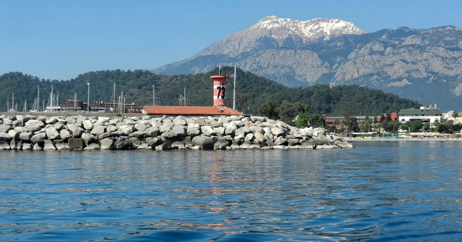 Breakwater and harbour light of Kemer Marina with snow on the mountains behind, the Antalya-side base for the Paris wreck
