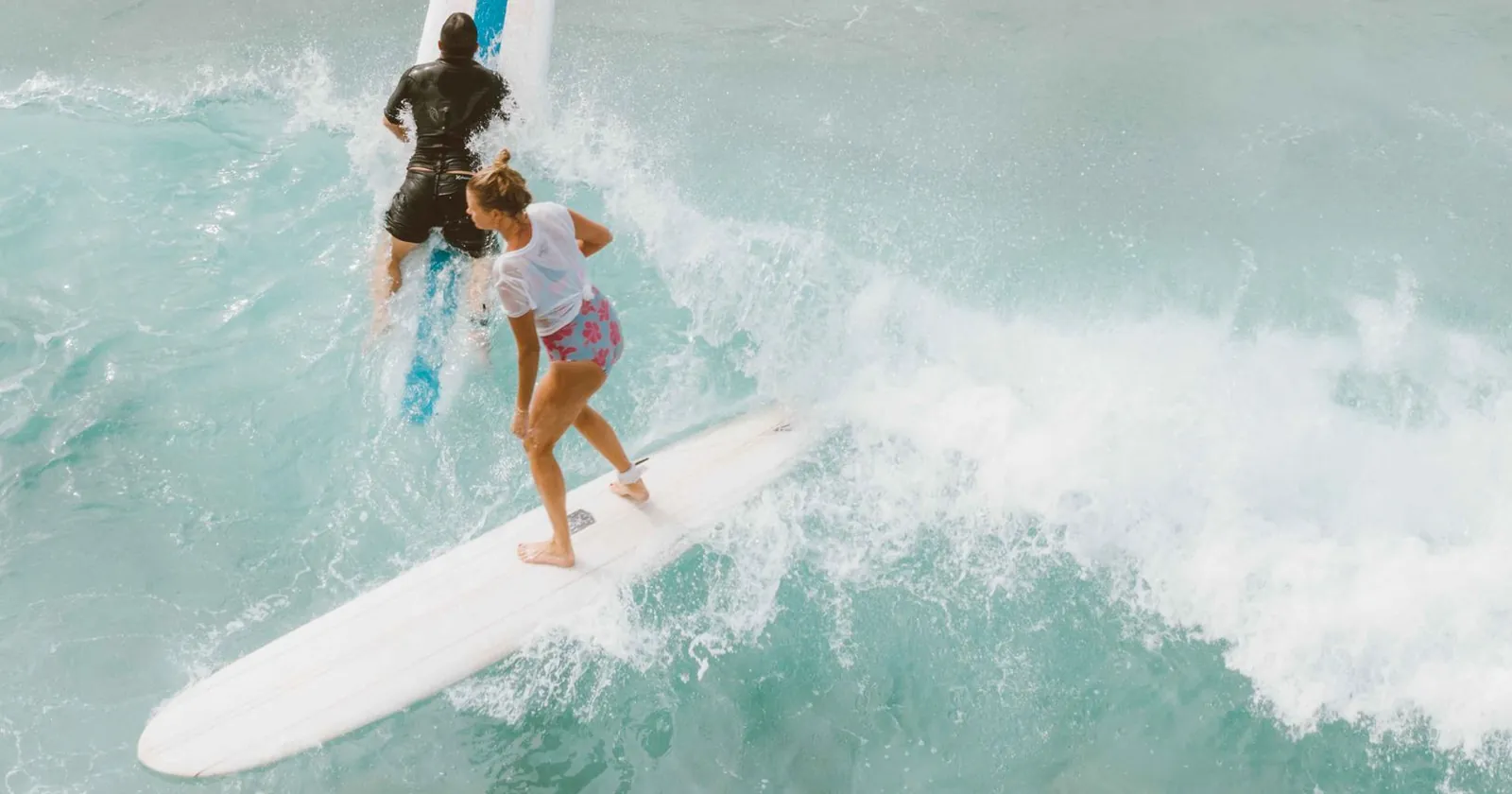Surfer standing on a board riding a wave