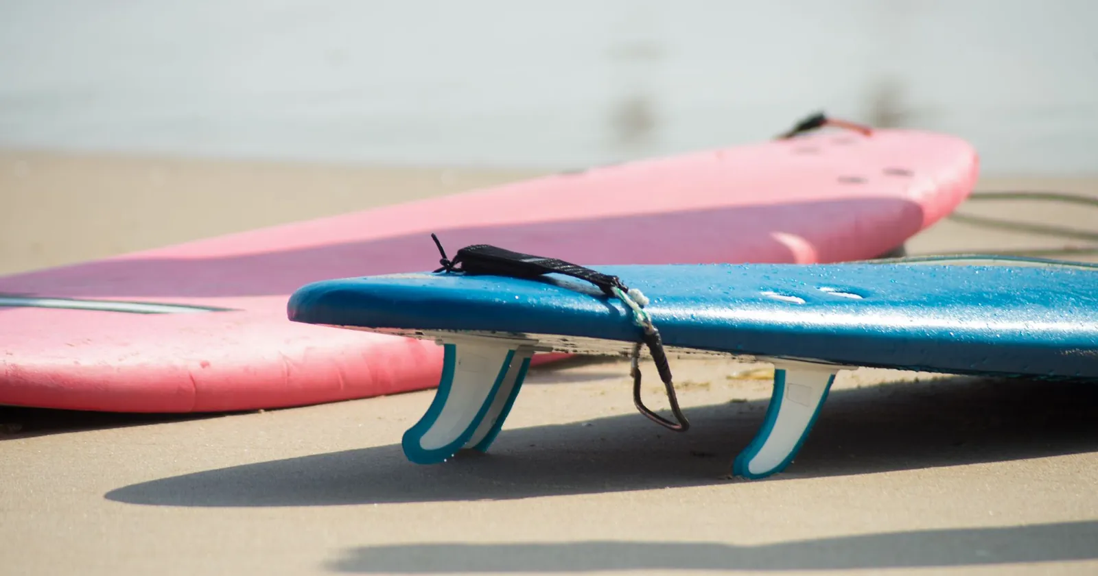 Surfboard on a beach at sunset