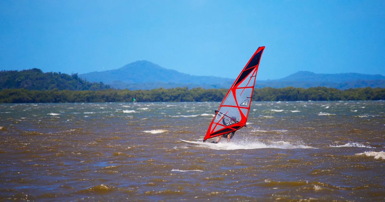 Windsurf board and rig on a beach