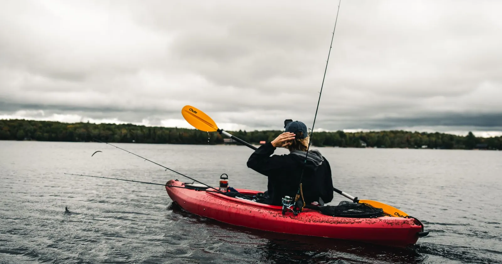 Angler standing to fish from a wide stable kayak