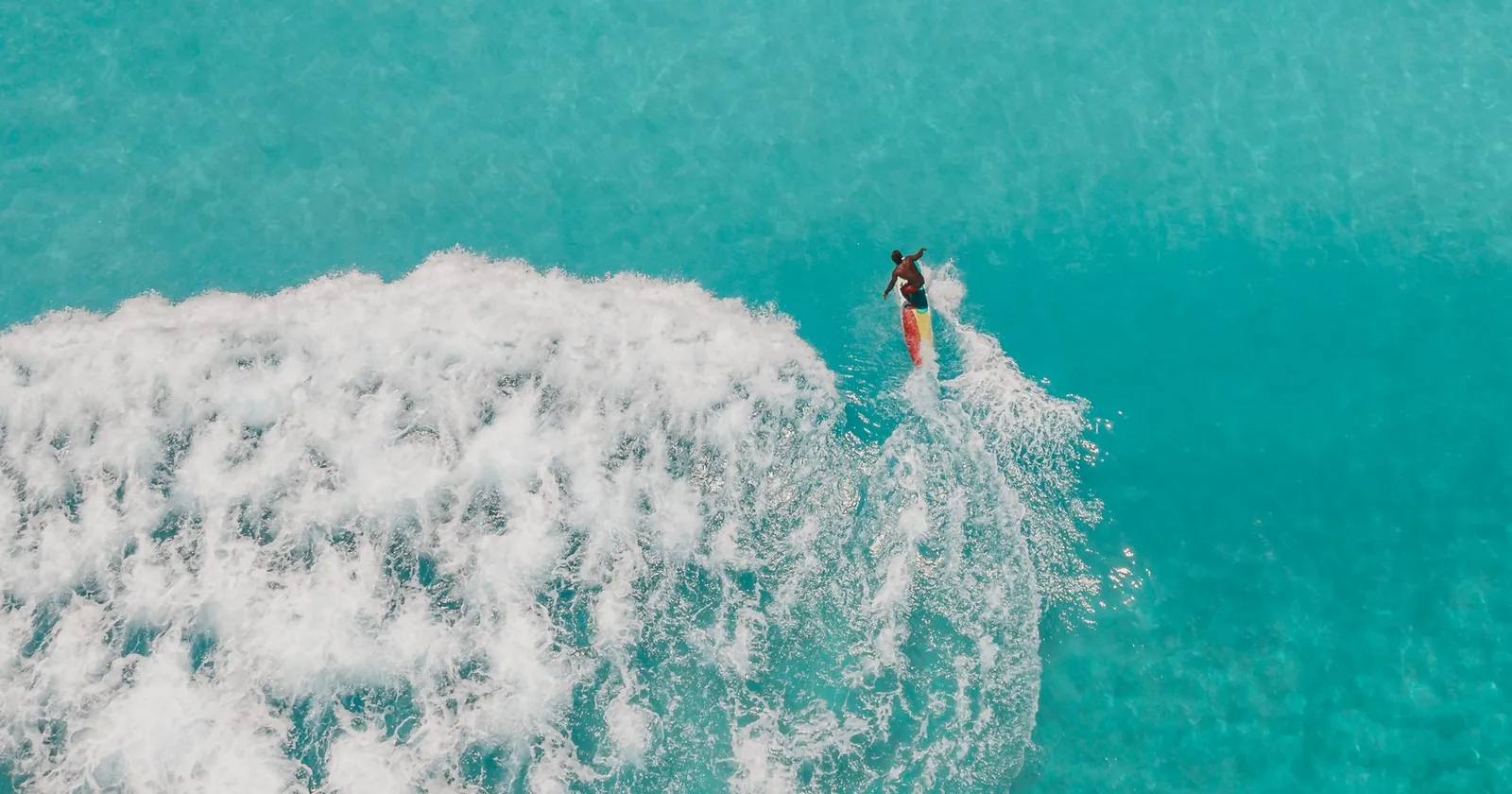Surfer walking to the water, generic surf destination