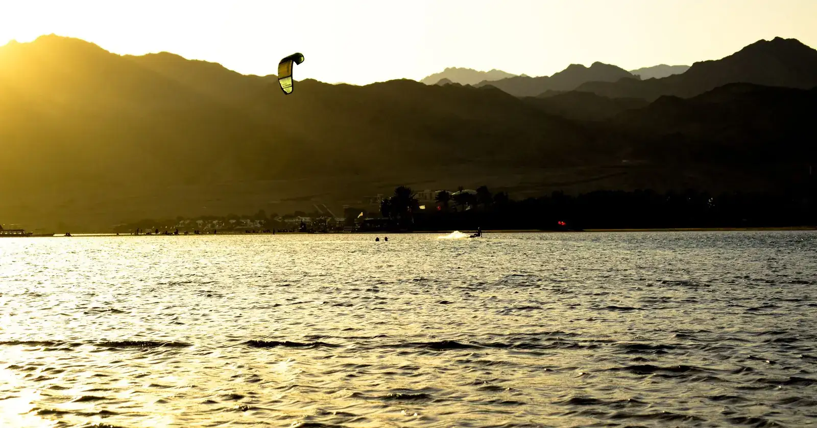 Experience the thrill of kitesurfing during sunset in Dahab,