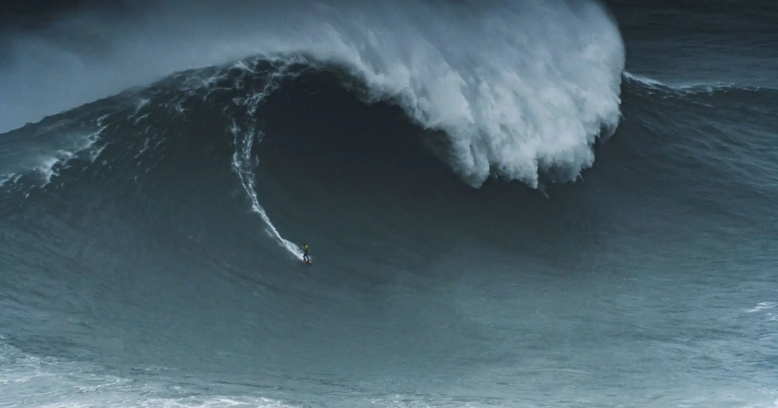 Surfing the massive waves of Nazaré, Portugal. Feel the adre