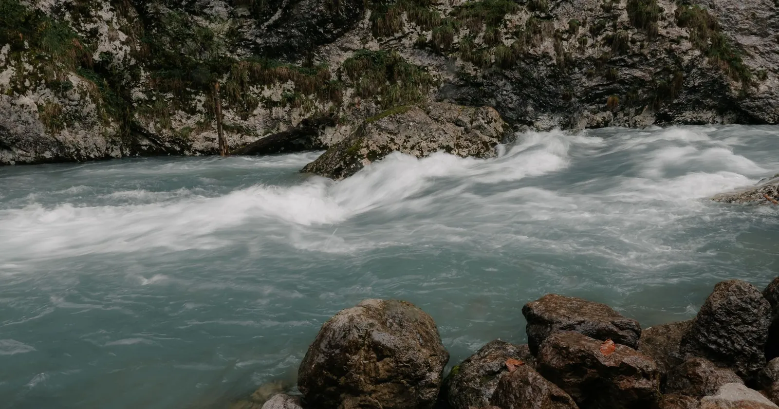Raft dropping into a large whitewater rapid on a river