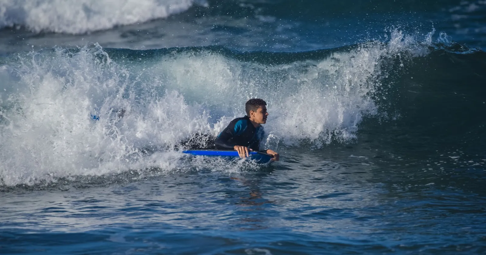 Bodyboard, swim fins and leash on the sand