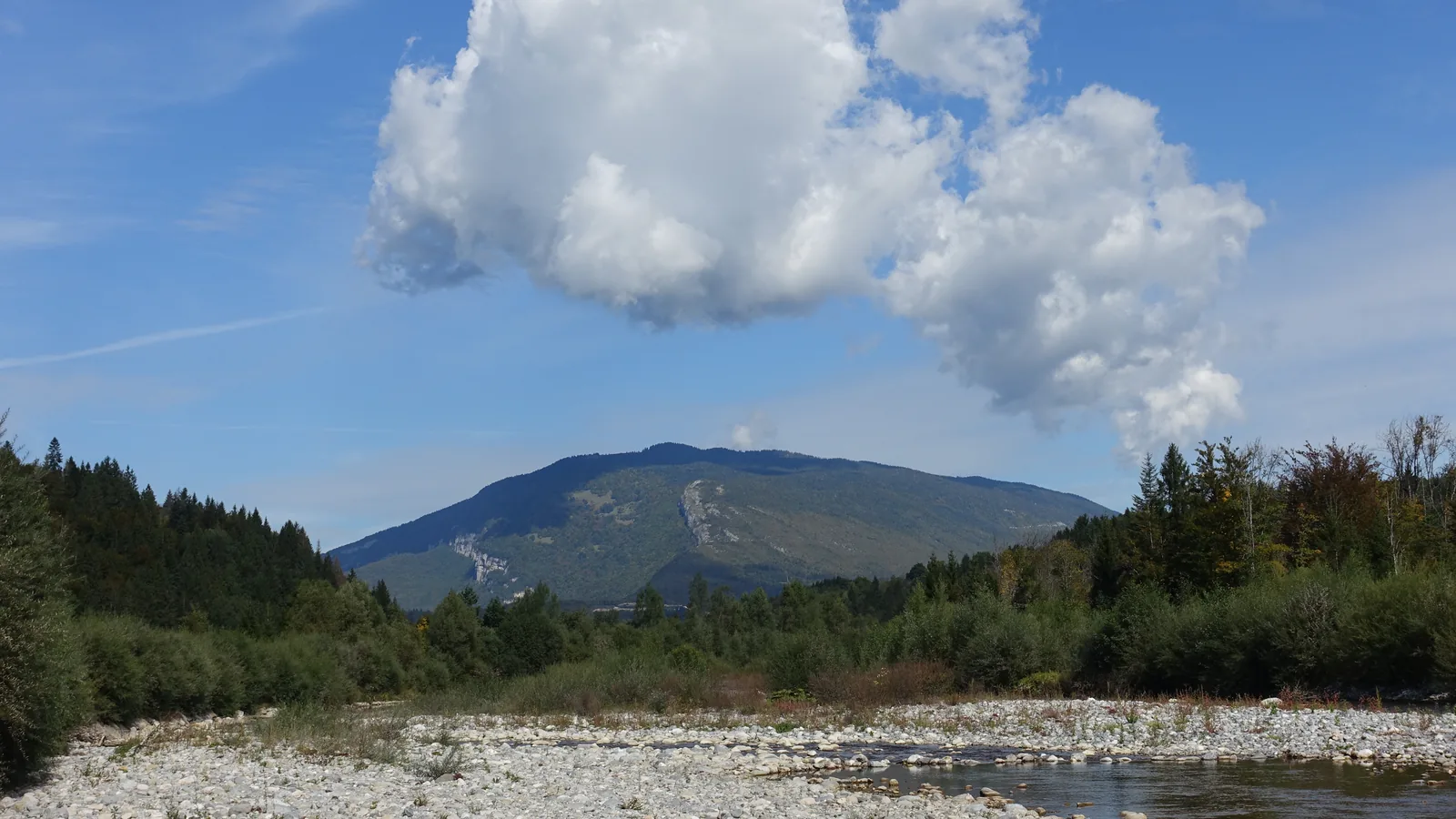 The Cheran river at Les Iles du Cheran near Lescheraines, Savoie, with the Semnoz ridge behind