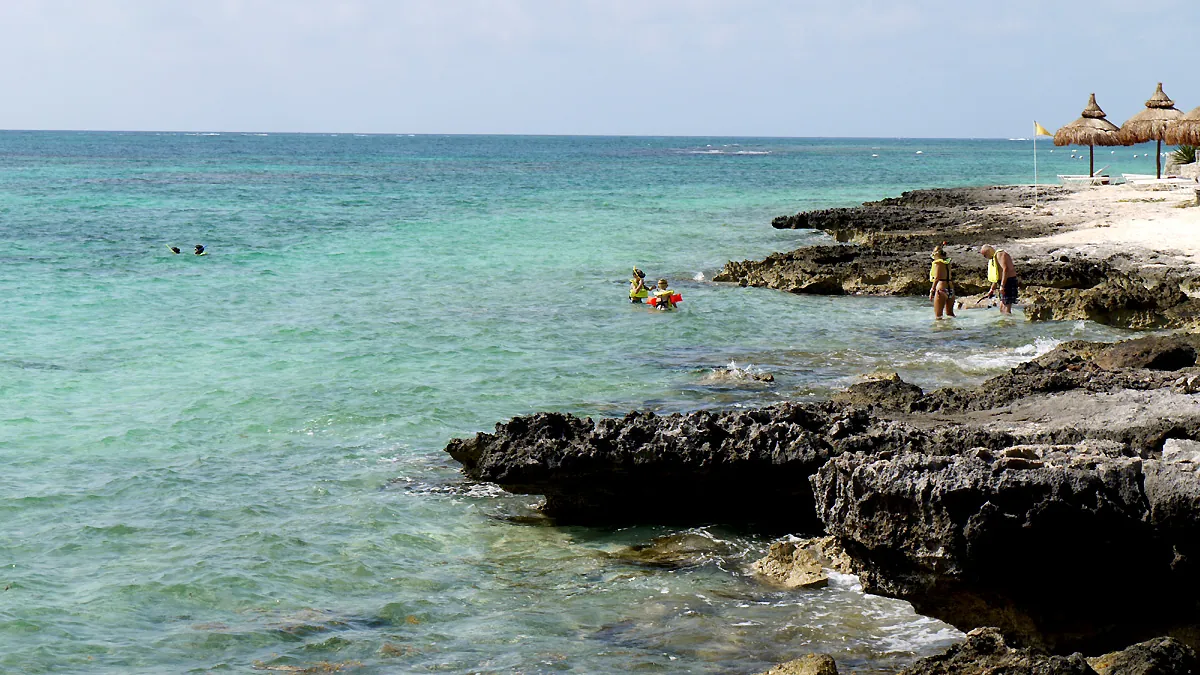 Snorkelers off the rocky shore at Punta Nizuc, the southern polygon of the national park that covers Cancun diving