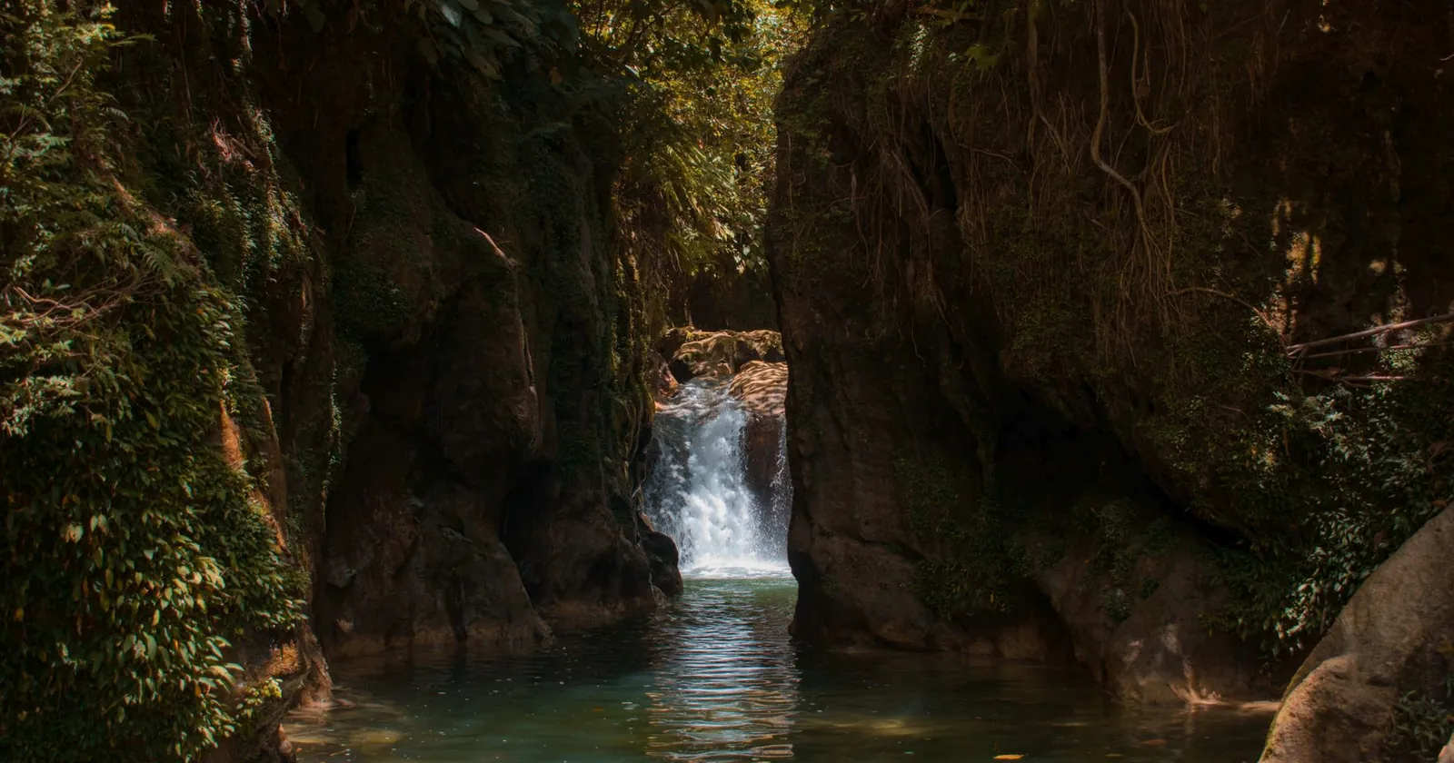 Canyoner abseiling down a waterfall in a gorge