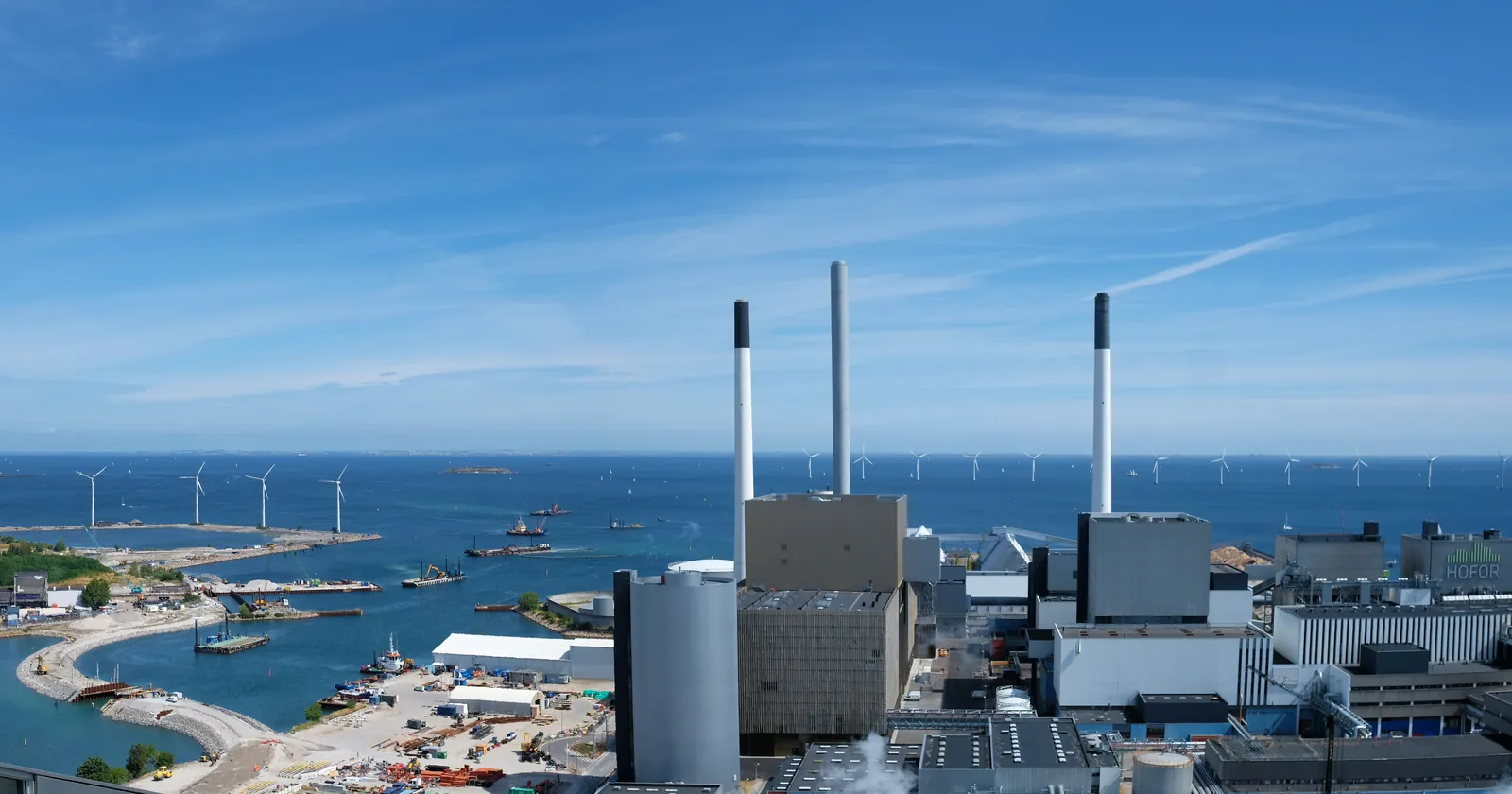 The harbour at Amager in Copenhagen with the Amagervaerket power station on Kraftvaerksvej and offshore wind turbines beyond