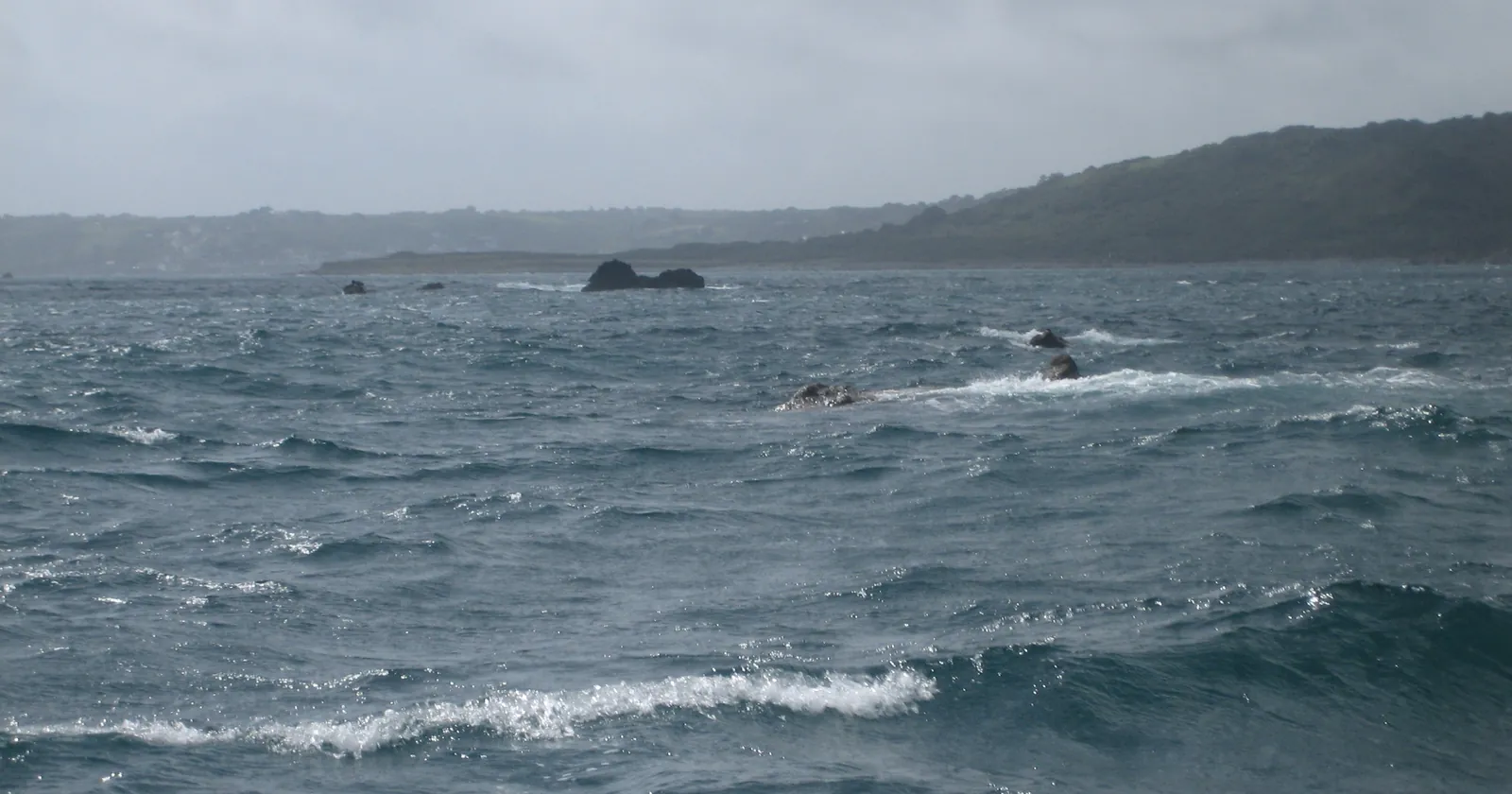 The Manacles rocks off the Lizard peninsula in rough gray water, the reef at the center of Cornwall diving, looking south-west towards Coverack