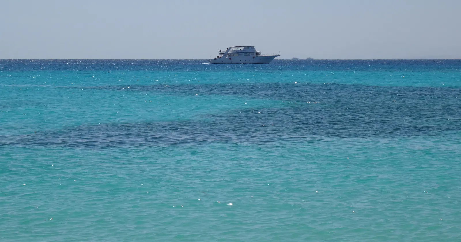 Boat over turquoise reef water off Mahmya on Giftun Island near Hurghada