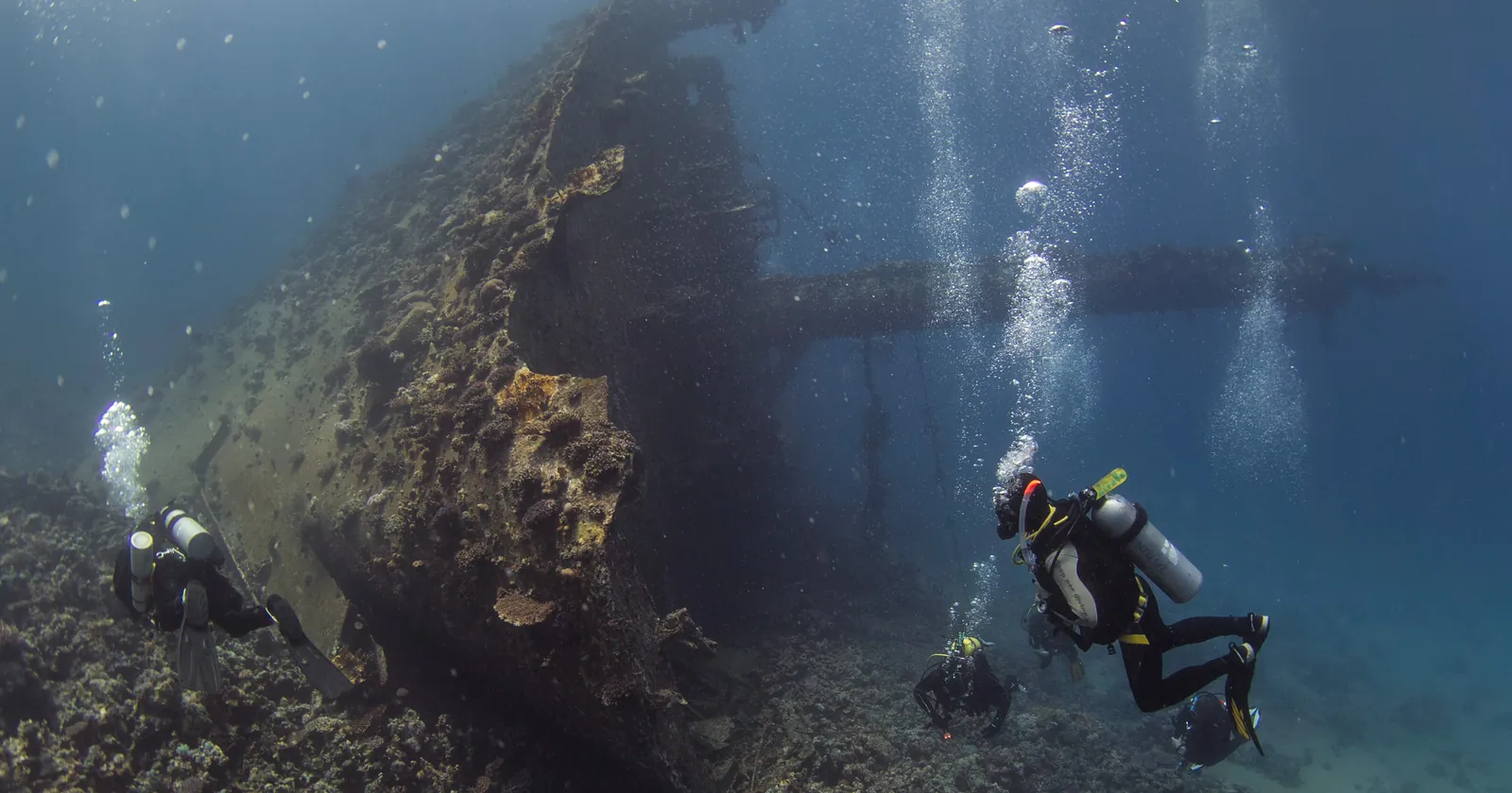 Scuba divers at the bow of the Giannis D wreck on Abu Nuhas reef, a dive trip from El Gouna