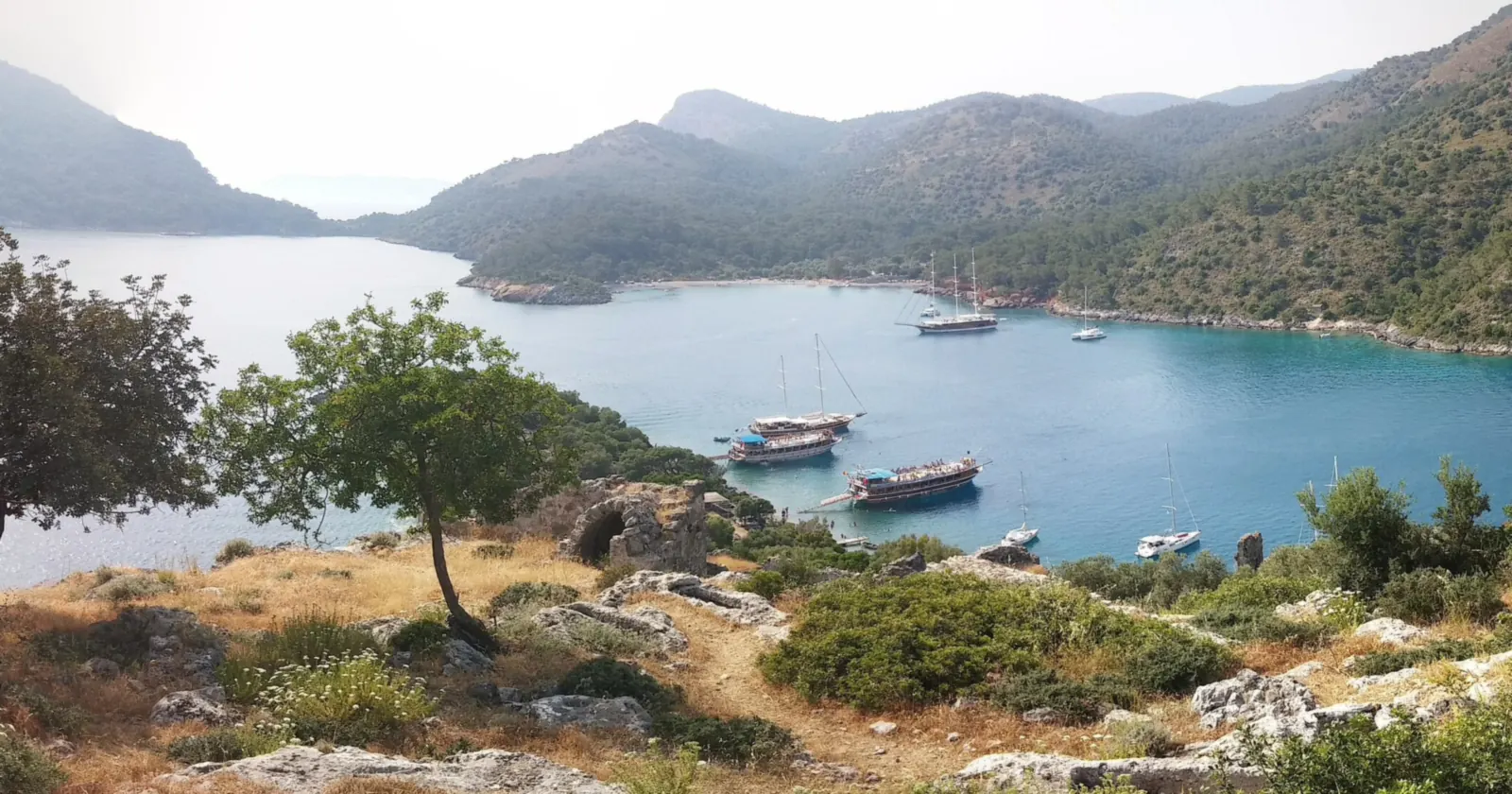 Gulets and yachts moored in the bay beside Gemiler Island near Fethiye, seen from the island's Byzantine ruins, inside one of the closed zones for Fethiye diving