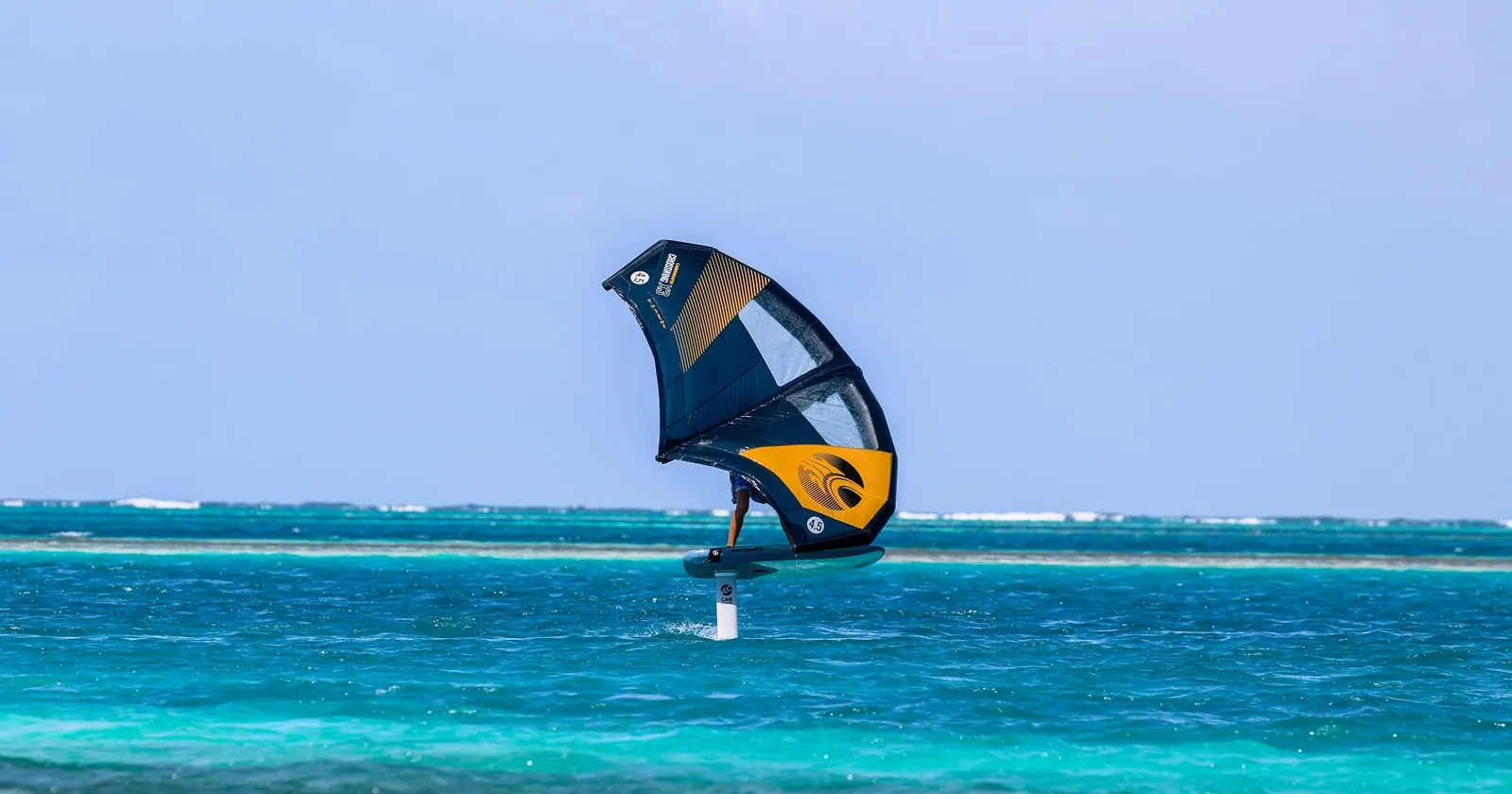 Wing foiler riding on a hydrofoil in the wind
