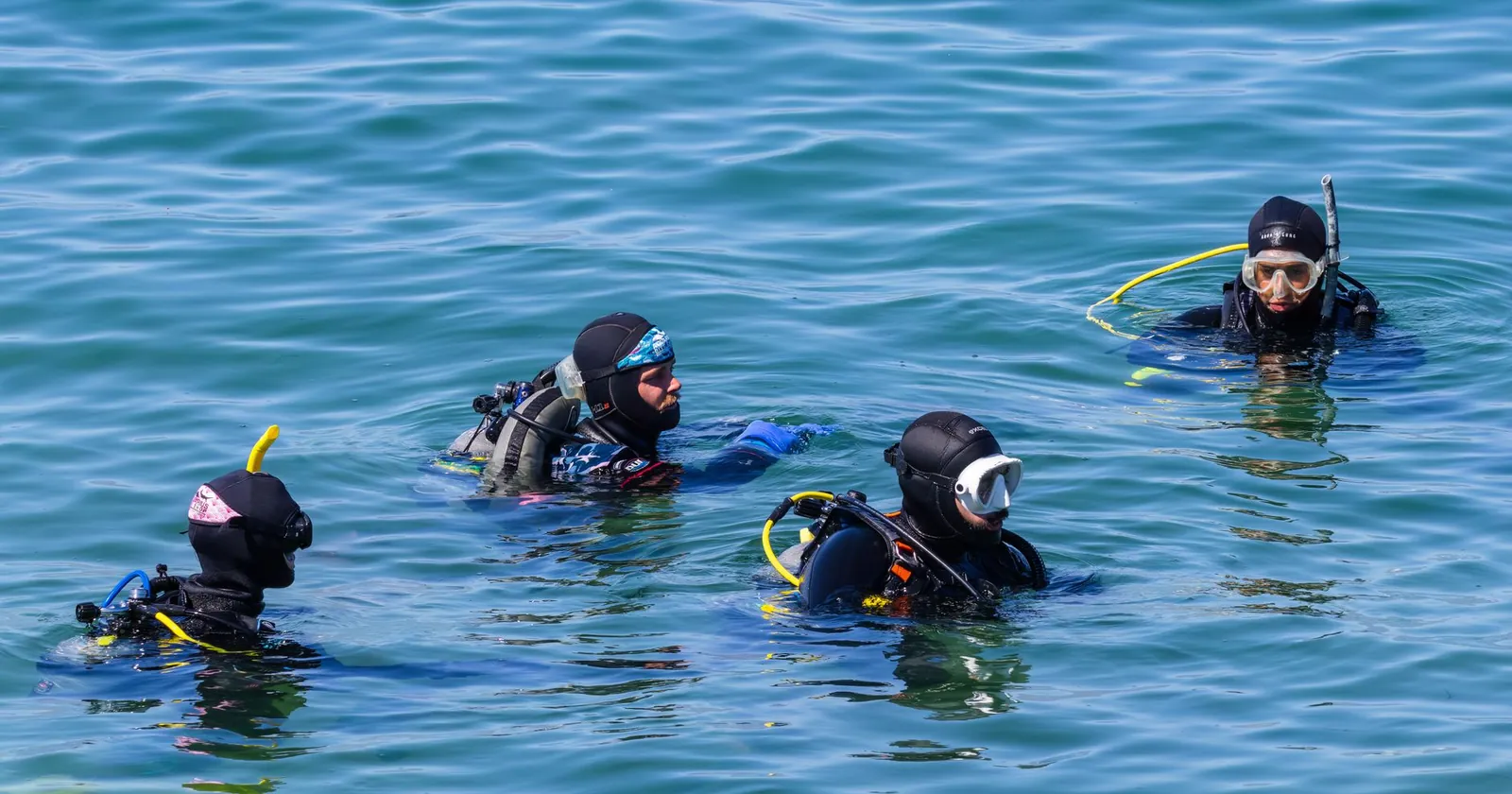 Scuba diver in open water with full kit, newly certified diving abroad