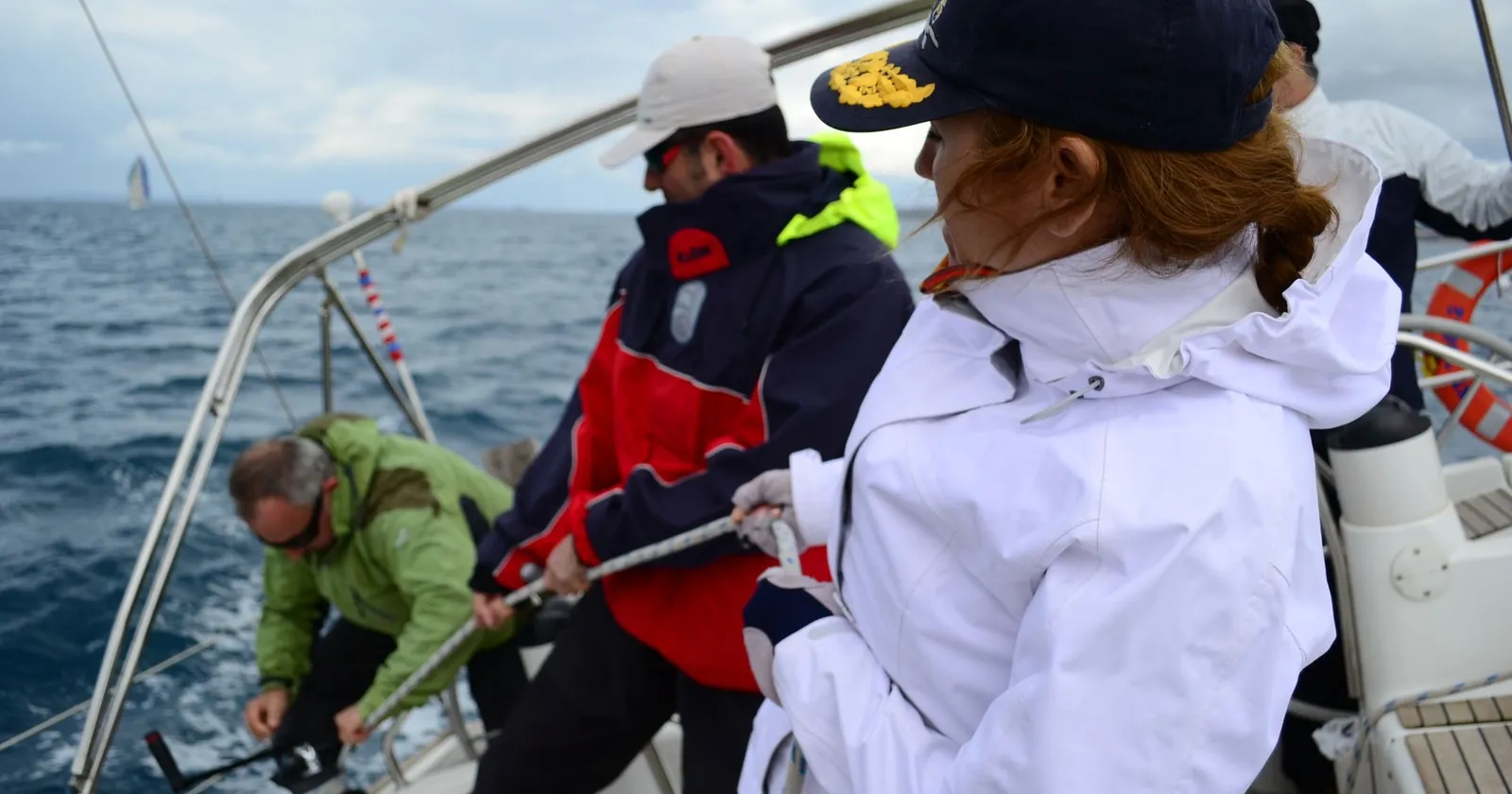 Crew member helming a sailboat on watch