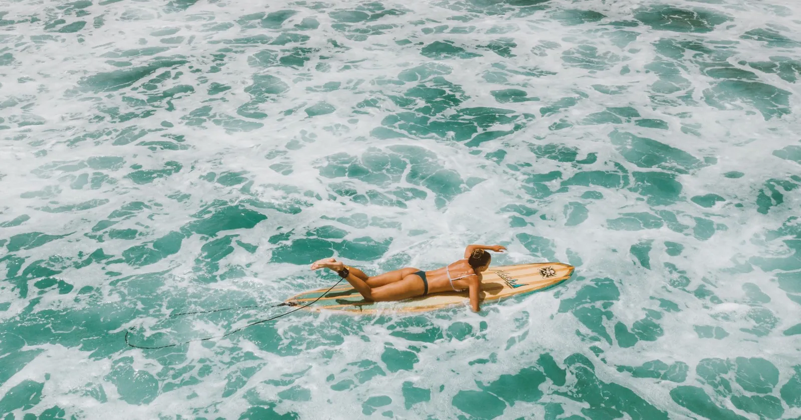 Surfer timing a paddle out between sets