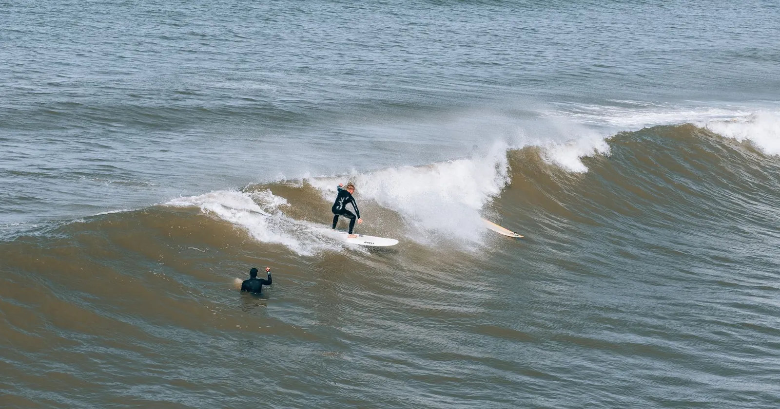 Surfer paddling out through whitewater