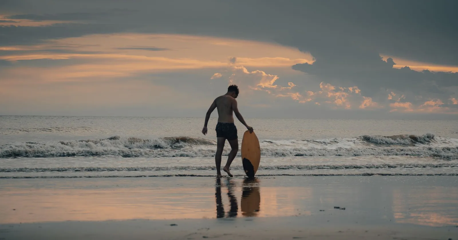 Skimboarder dropping the board and stepping on while running