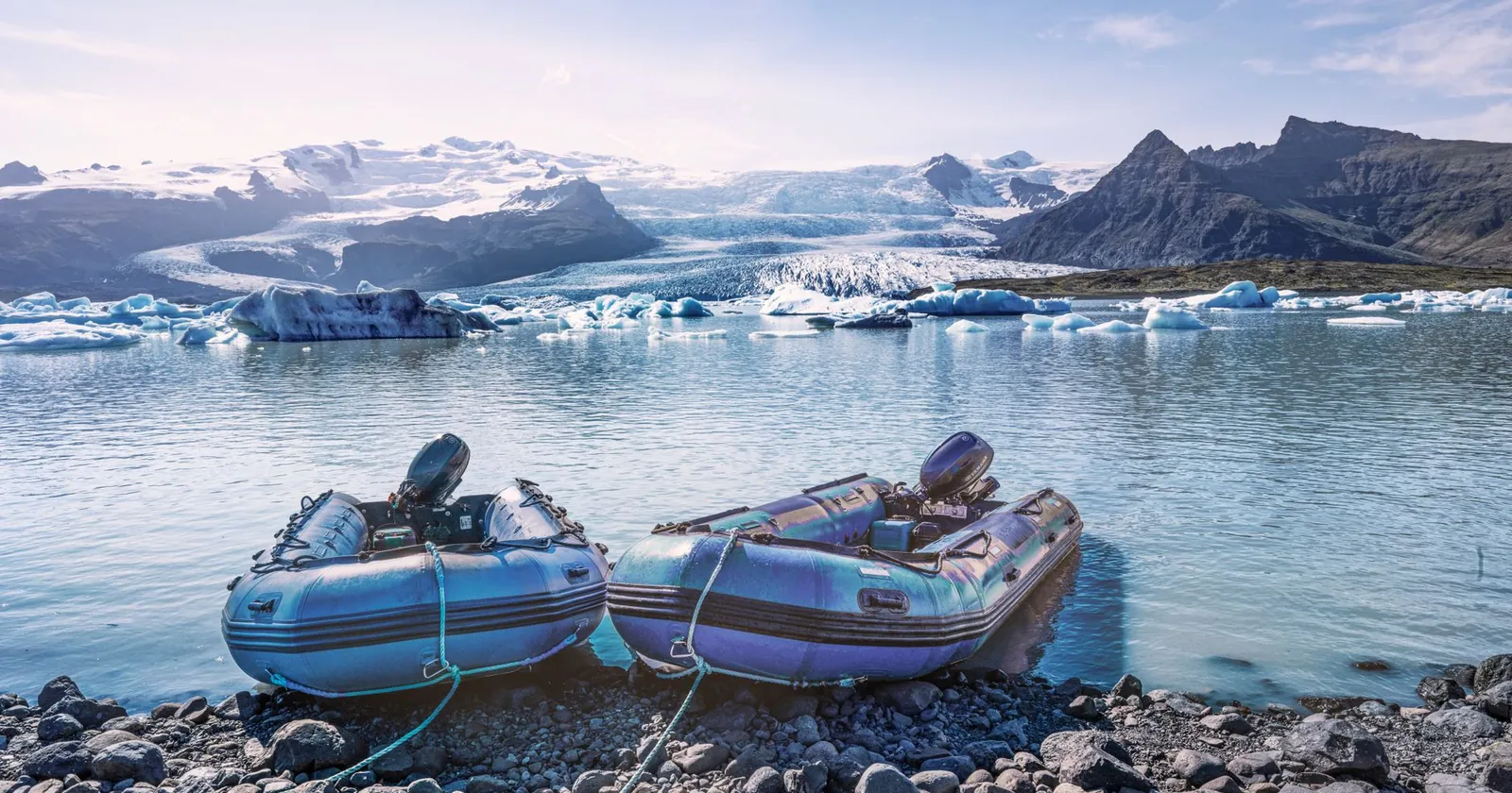 Packrafter paddling an inflatable raft on a mountain lake