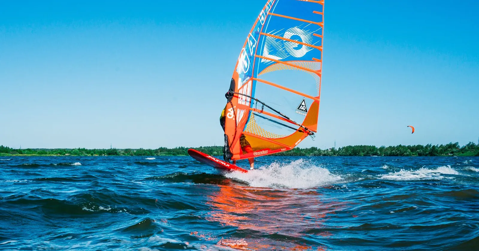 Windsurfer sailing on flat water