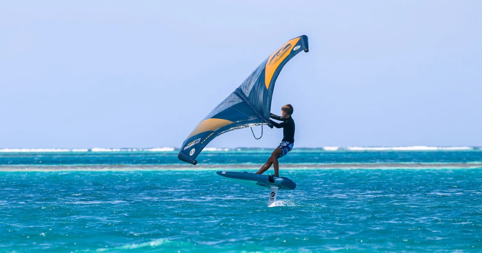 Wing foiler riding above the water