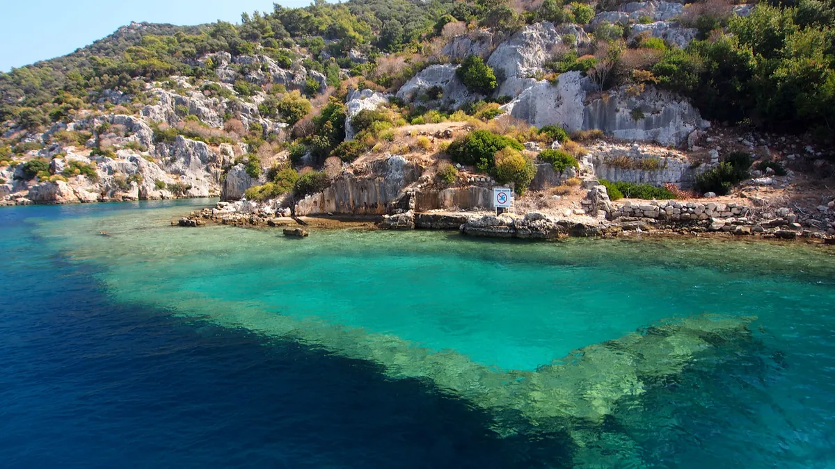 Submerged Lycian walls in clear turquoise water off the north shore of Kekova island near Kaş, a site inside closed diving box A16