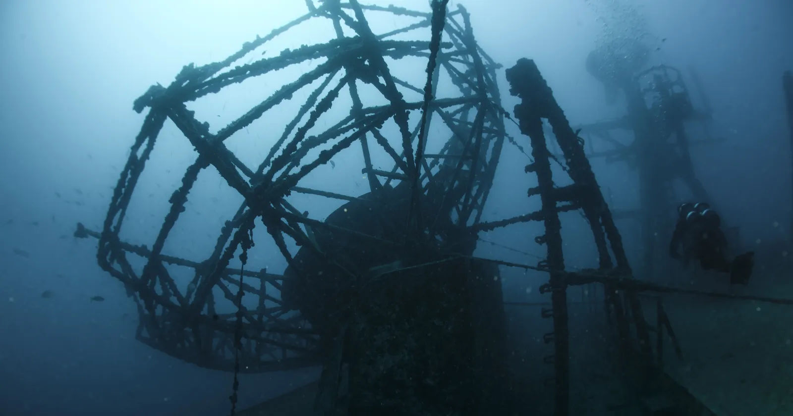 A diver swims past the antenna structure on the deck of the Vandenberg, a Key West diving wreck lying in 145 feet of water
