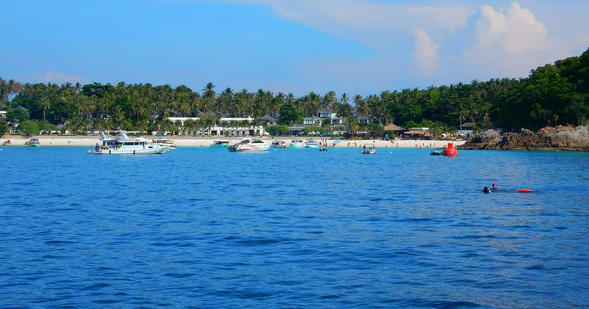 Dive and day boats on moorings in Patok Bay on Racha Yai, a Phuket day-trip dive site that stays open when the Similans close