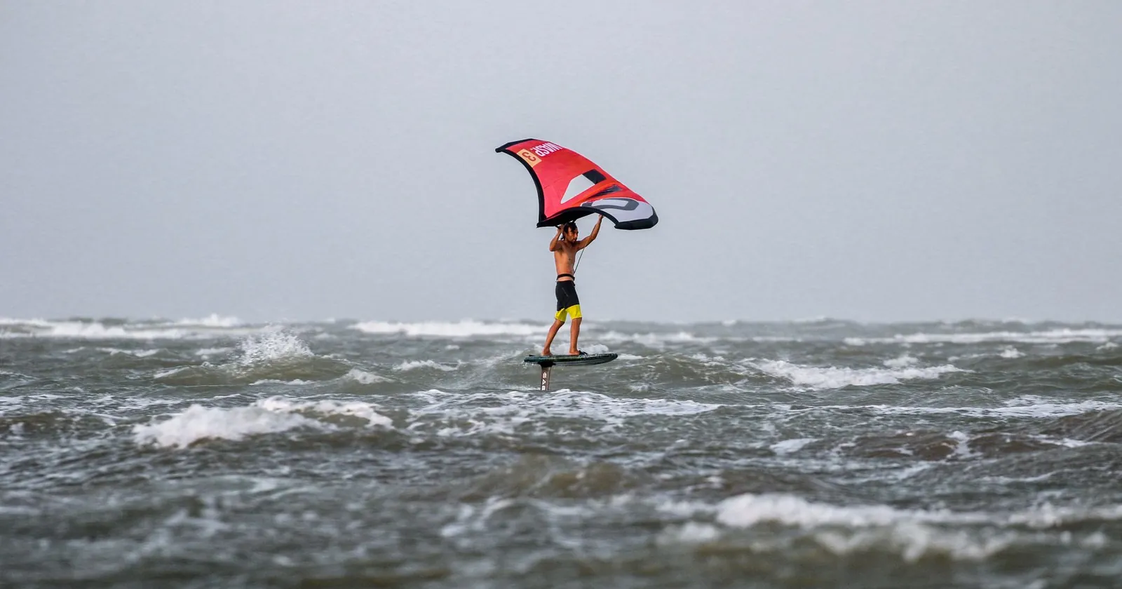 Wind-powered board rider on the water