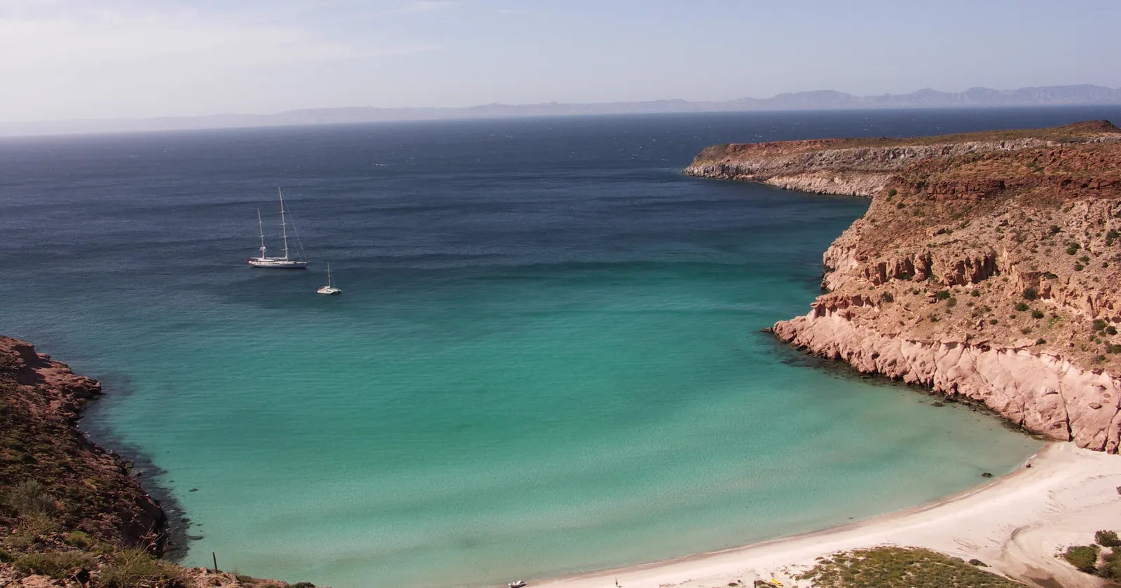 Ensenada Grande on Isla Partida, with turquoise water inside the marine national park that covers most La Paz diving, and two yachts at anchor