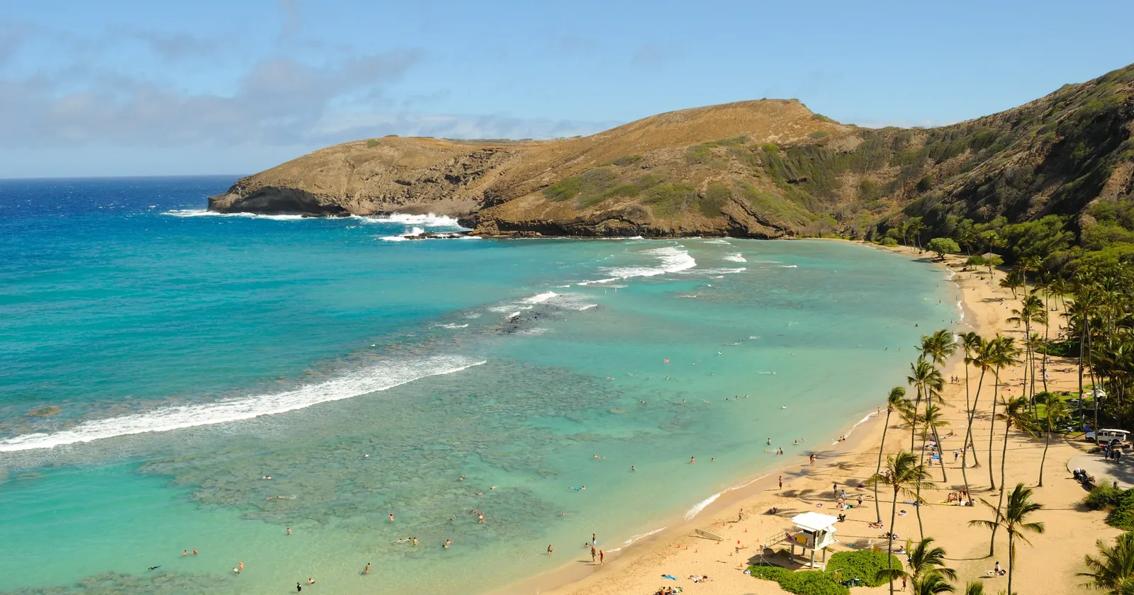 Hanauma Bay on Oahu seen from the crater rim, with the shallow fringing reef, the sandy beach and the open mouth of the bay where Oahu diving goes deeper