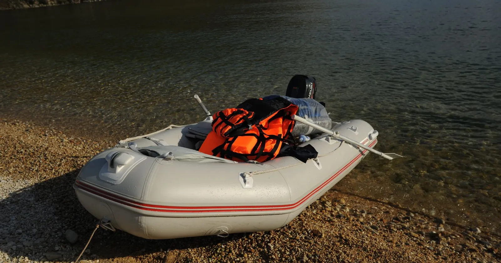 Packraft, breakdown paddle and inflation bag laid out