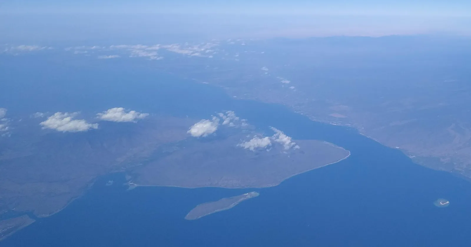 Aerial view of Menjangan Island off the western tip of Bali, the national park island reached on Pemuteran diving trips, with the Bali Strait beyond
