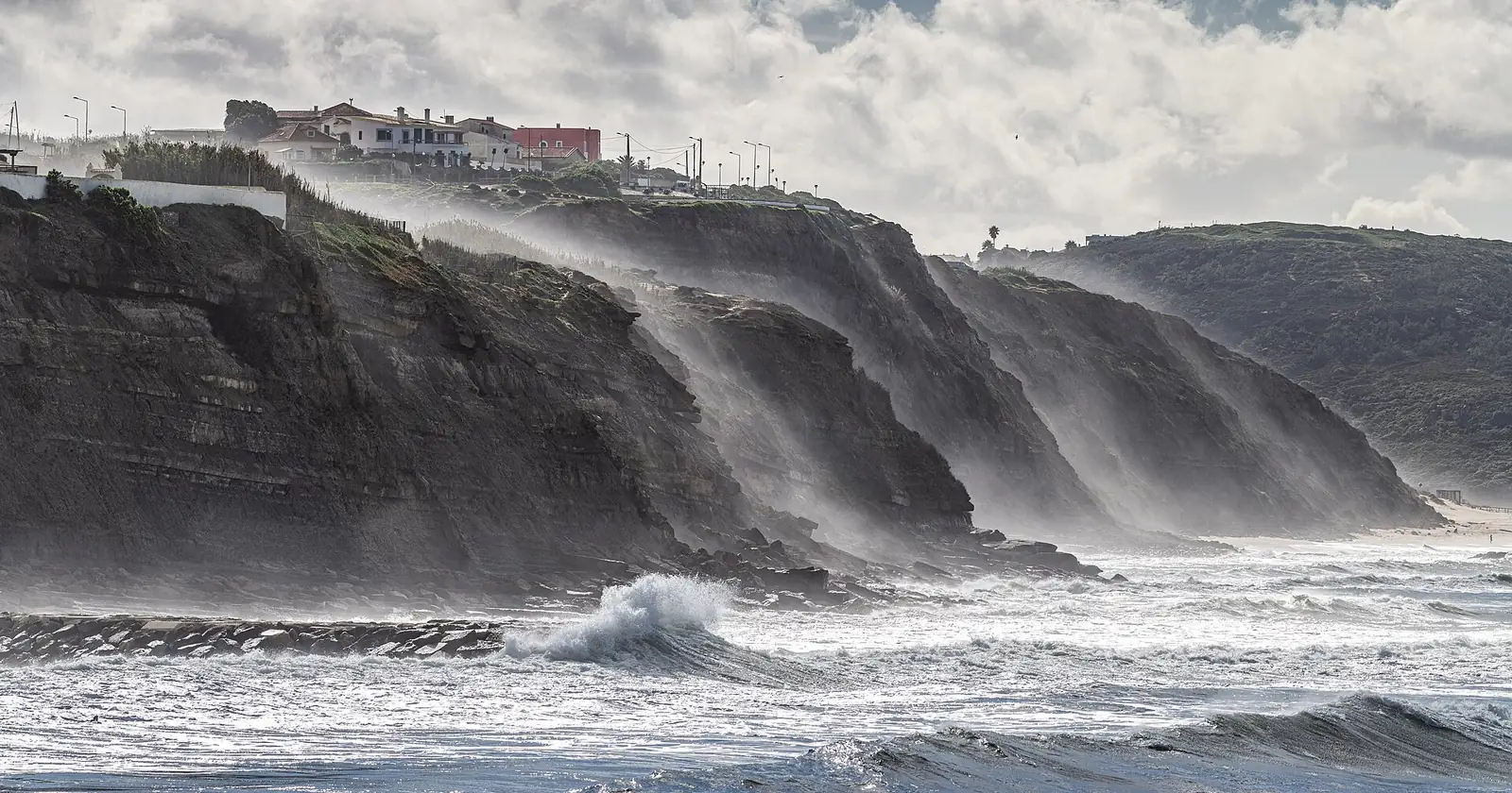 Atlantic swell breaking below the cliffs at Ericeira, Portugal, a D8 visa surf base
