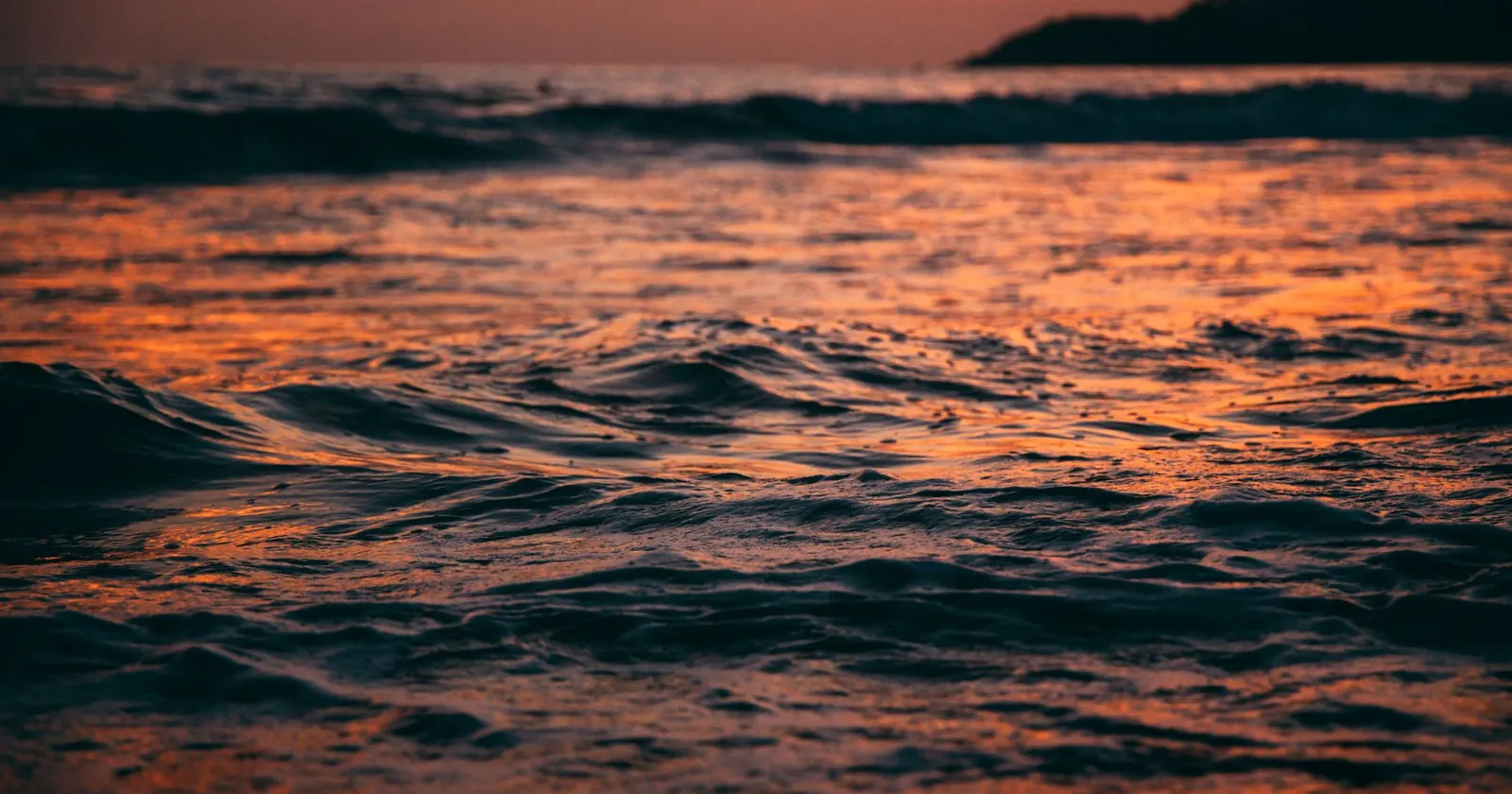 Longboard planted in the sand on a Puerto Escondido beach at sunset