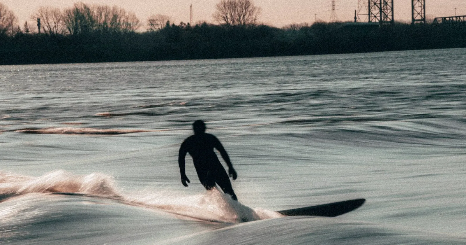 Surfers queueing to take turns on a river wave