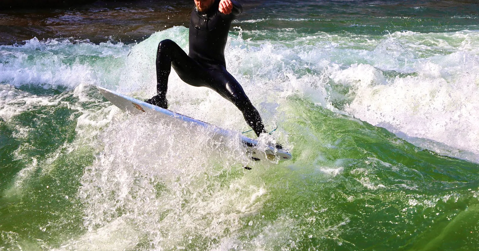 Surfer riding a standing wave on a river