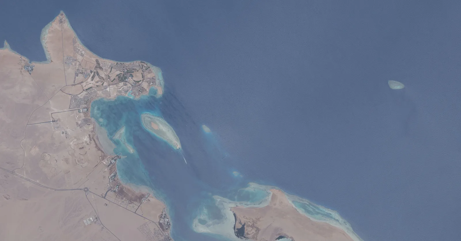 Safaga diving coast from the International Space Station in July 2026, with fringing reefs, the bay north of Port Safaga and Safaga Island at lower right