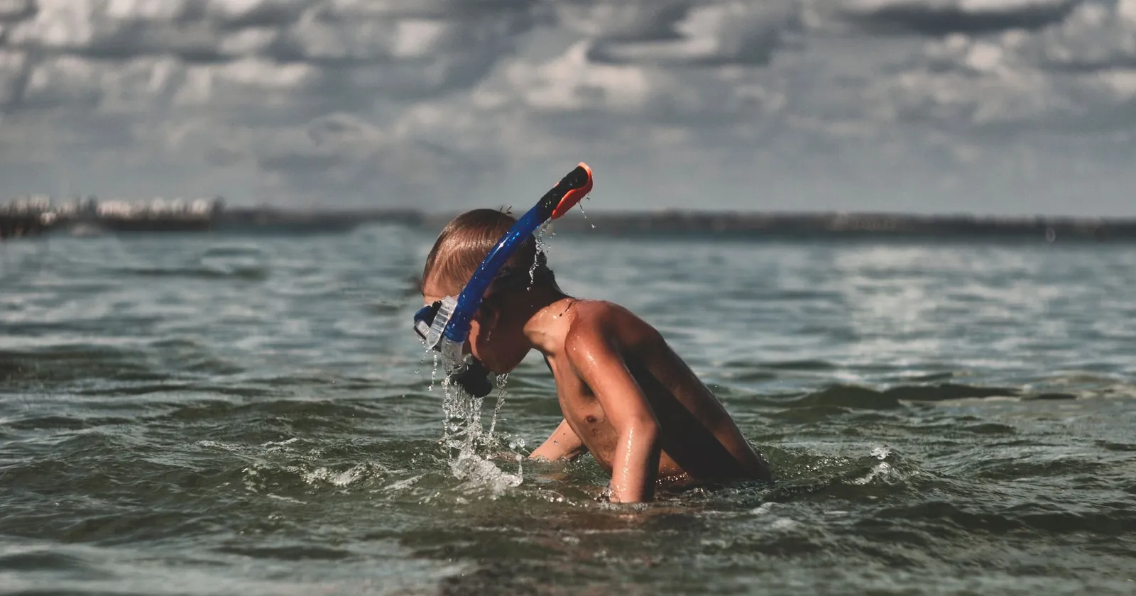 Family snorkelling together in a calm shallow bay