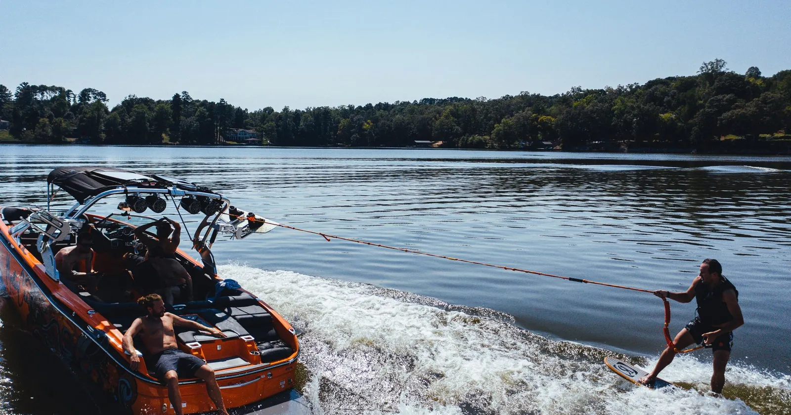 Wakeboarder strapped in holding the rope while being towed