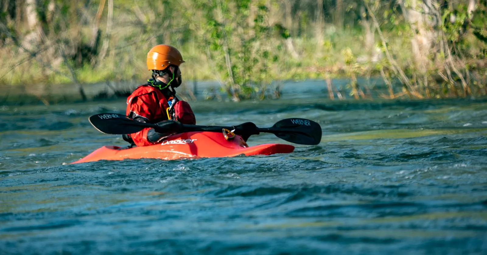 Paddler wearing a buoyancy aid and whitewater helmet