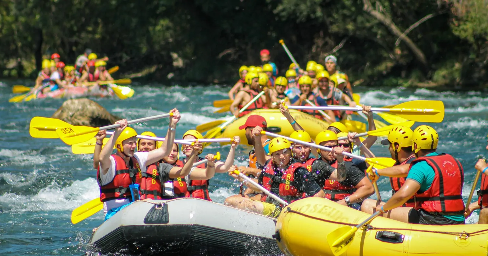Rafting guide briefing a team before launching